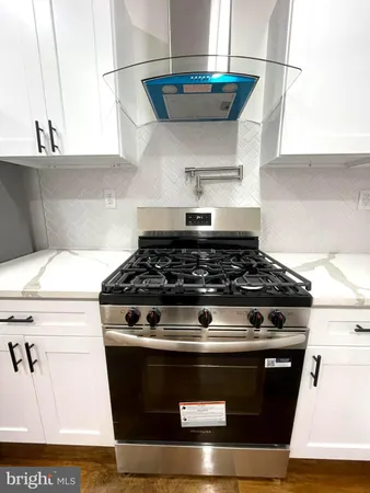 a kitchen with a refrigerator a sink and a stove