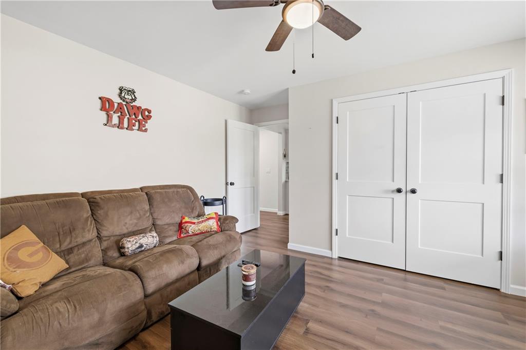 156 Pine Avenue Commerce, GA 30529 - Photo 14 of 35 a living room with furniture and a wooden floor