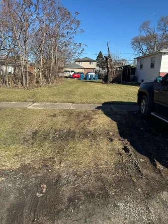 a view of yard with swimming pool and green space