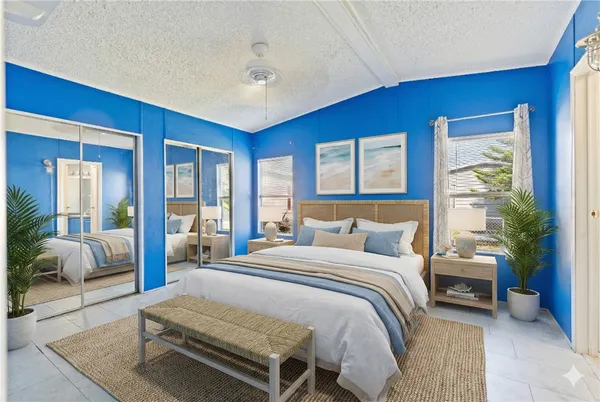 a bedroom with a large bed and a couch