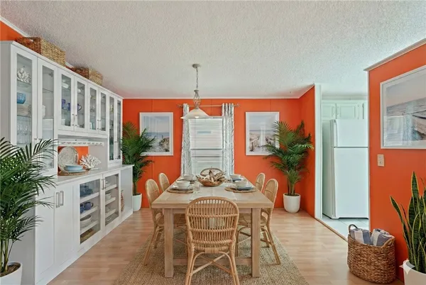 a dining room with furniture a flat screen tv and a floor to ceiling window