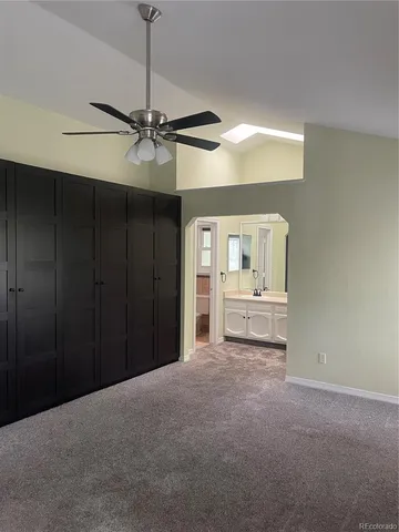 a view of a room with cabinet and a ceiling fan