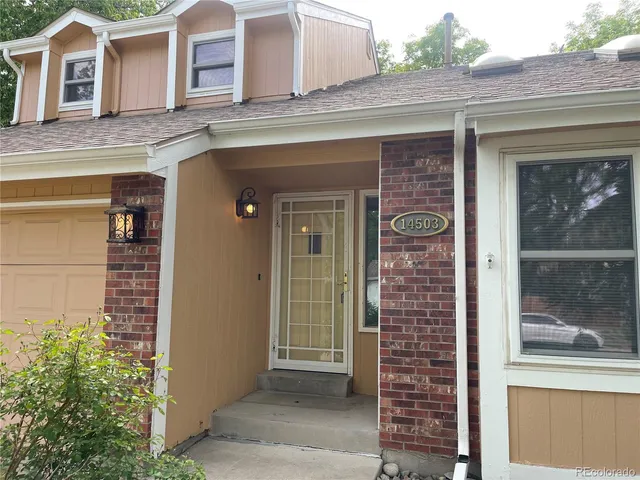 a view of a brick house with large windows