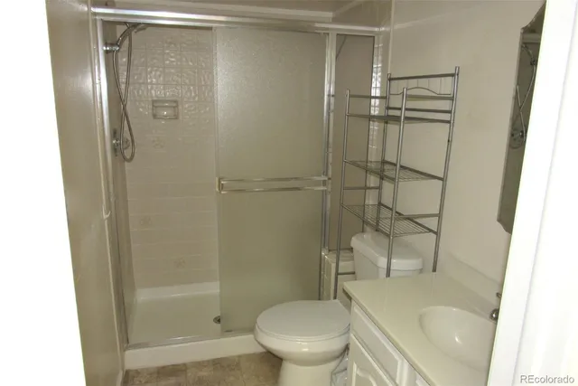 a bathroom with a shower and a toilet