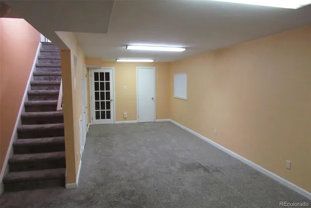 wooden floor in an empty room with stairs