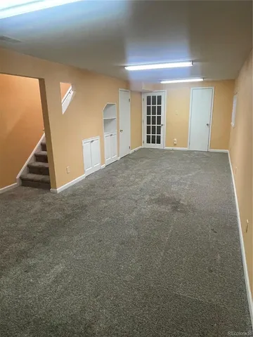 a view of empty room with stairs