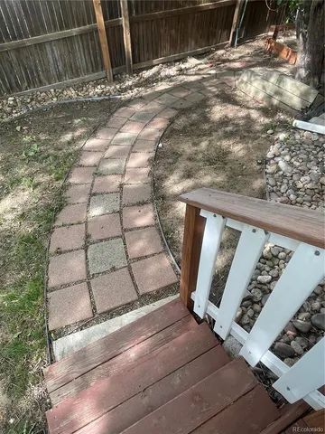 a view of a backyard with wooden fence