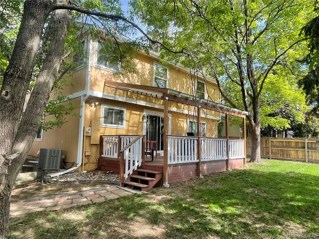a view of a house with a yard and sitting area