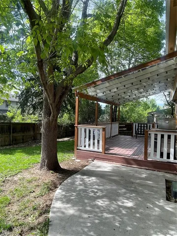 a view of a house with backyard and a tree