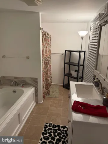 a bathroom with a bathtub and shower