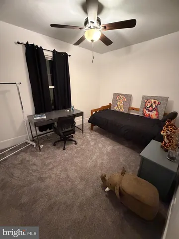 a living room with furniture and a air conditioner vent