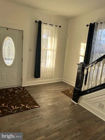 a view of a room with wooden floor and window