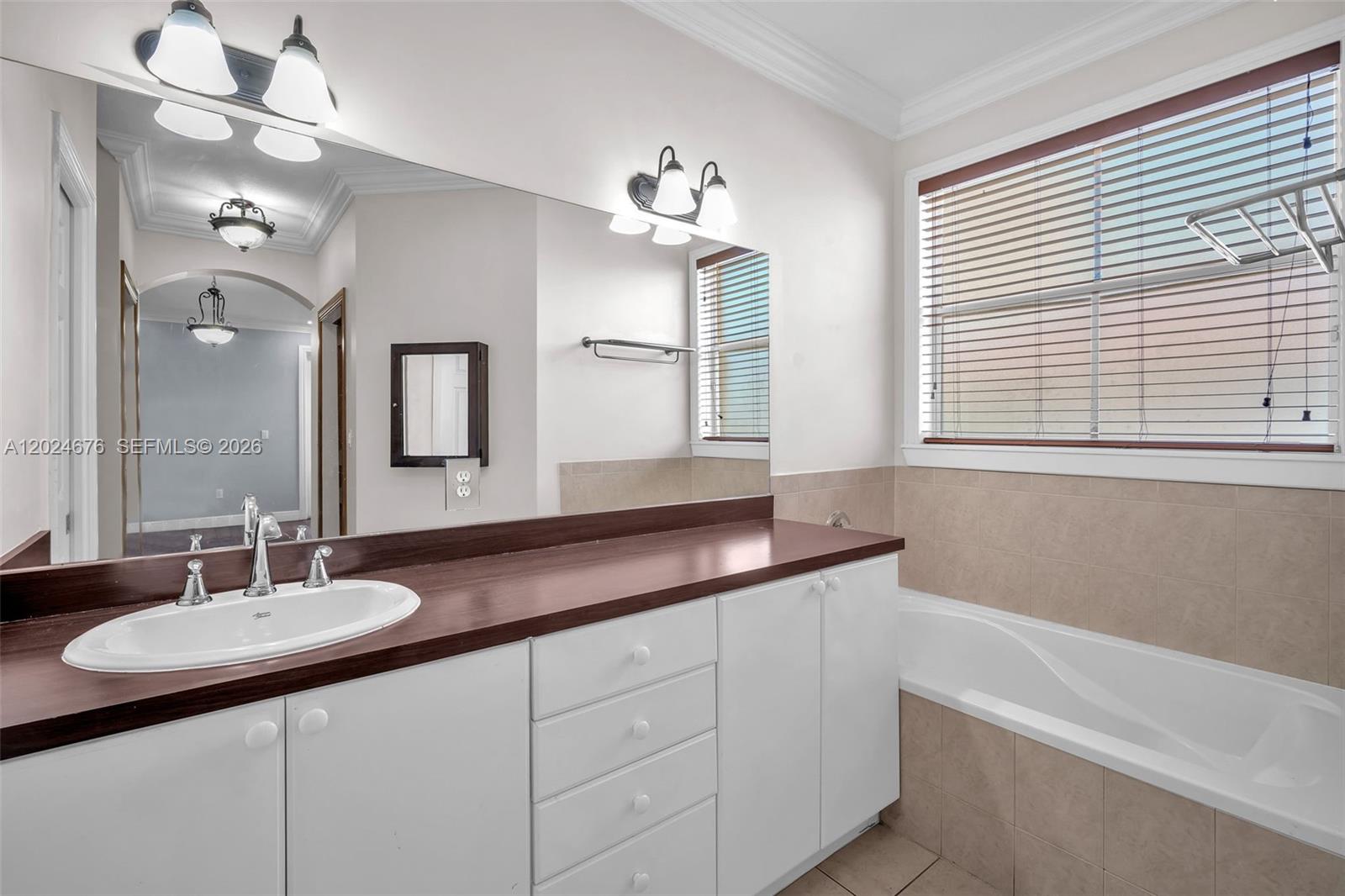 2155 Southwest 156th Court Miami, FL 33185 - Photo 48 of 57 a bathroom with a sink double vanity granite tub and a mirror