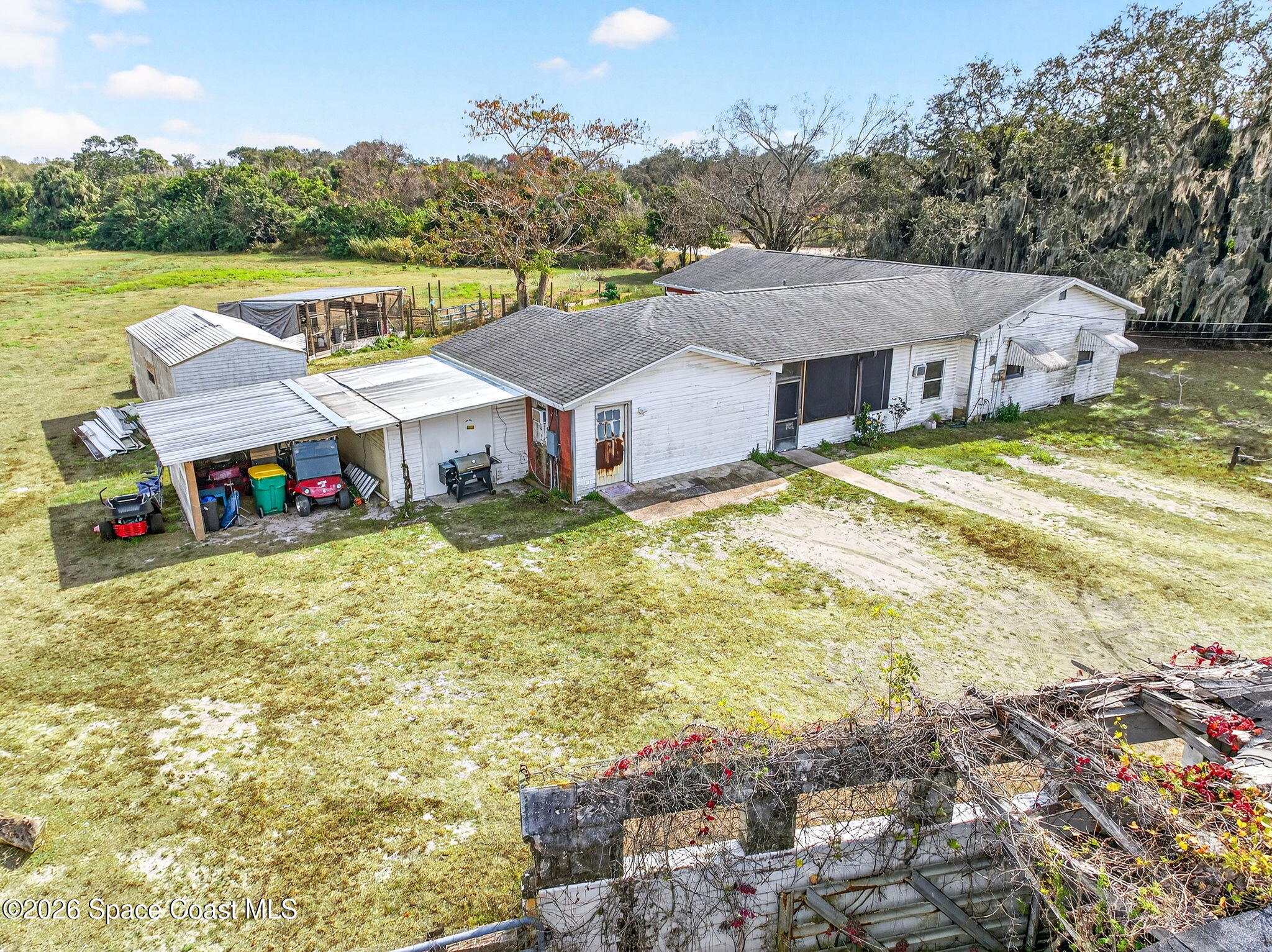 3825 Turtle Mound Road Melbourne, FL 32934 - Photo 10 of 19 a view of a house with swimming pool and a yard