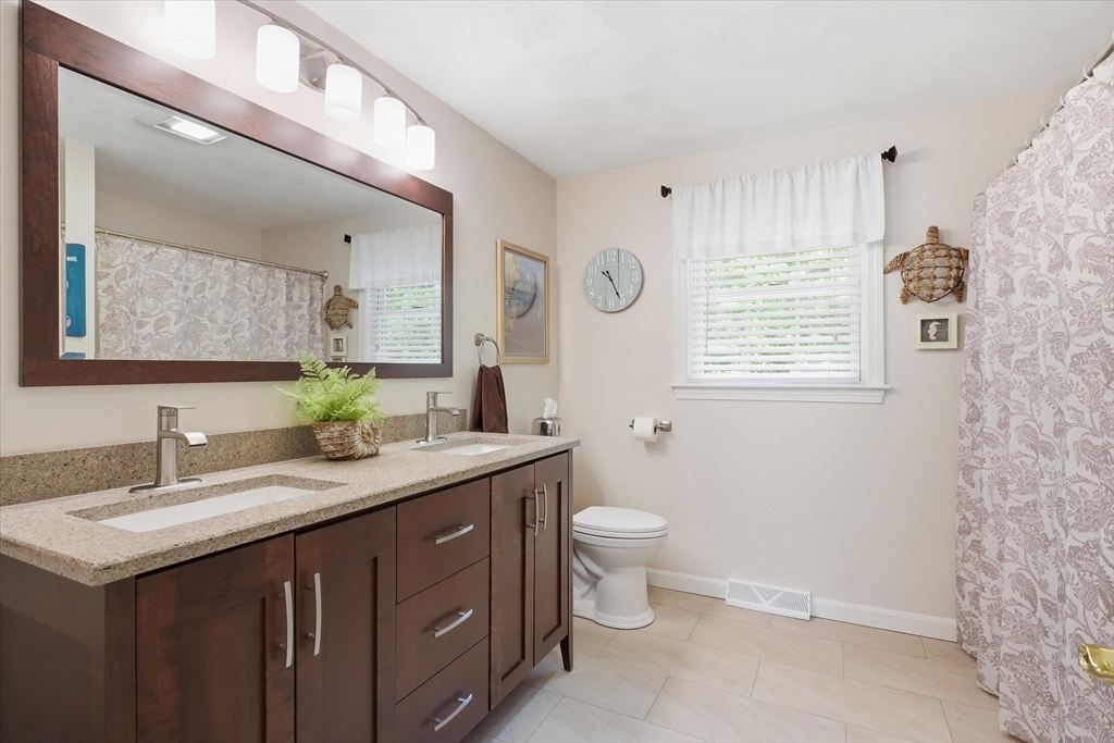 9 Fazio Farm Road Georgetown, MA 01833 - Photo 29 of 42 a bathroom with a granite countertop sink mirror vanity and toilet