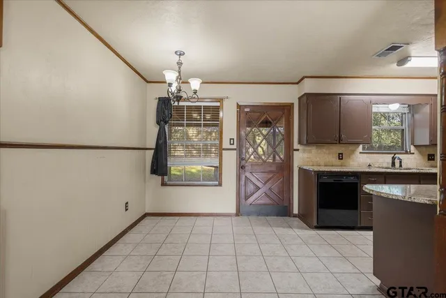 a kitchen with stainless steel appliances a refrigerator and a stove top oven