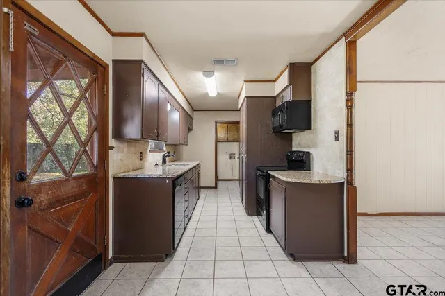 a kitchen with a sink cabinets and a stove