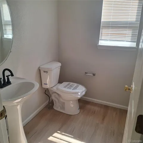a white toilet sitting next to a bathroom sink