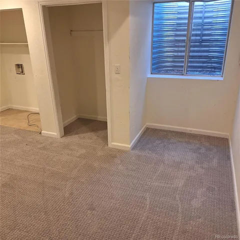 a view of a hallway with entryway and wooden floor