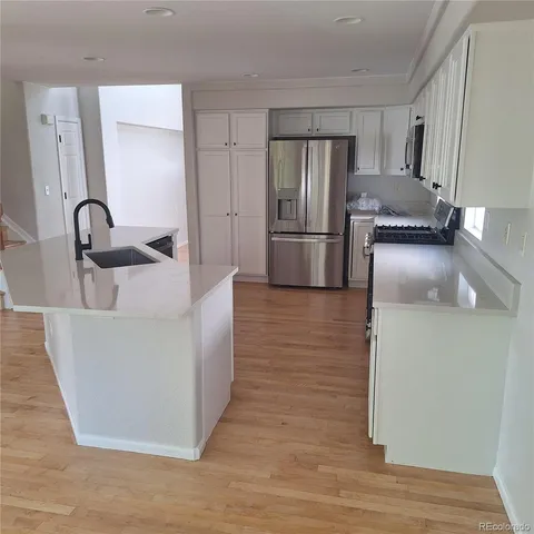 a kitchen with stainless steel appliances a refrigerator and a sink