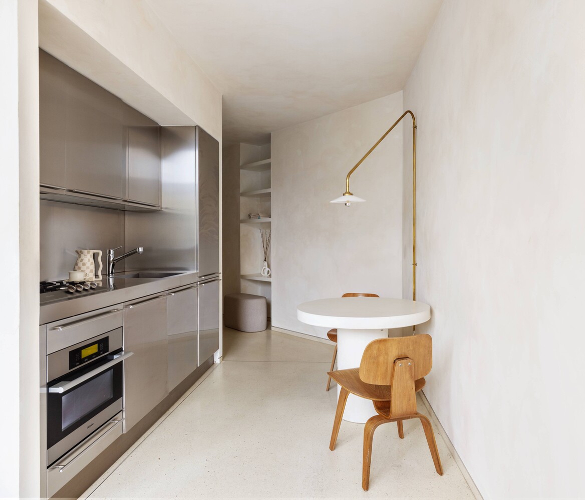 100 11th Avenue, Unit 3C Manhattan, NY 10011 - Photo 6 of 8 a bathroom with a sink a chair and a refrigerator