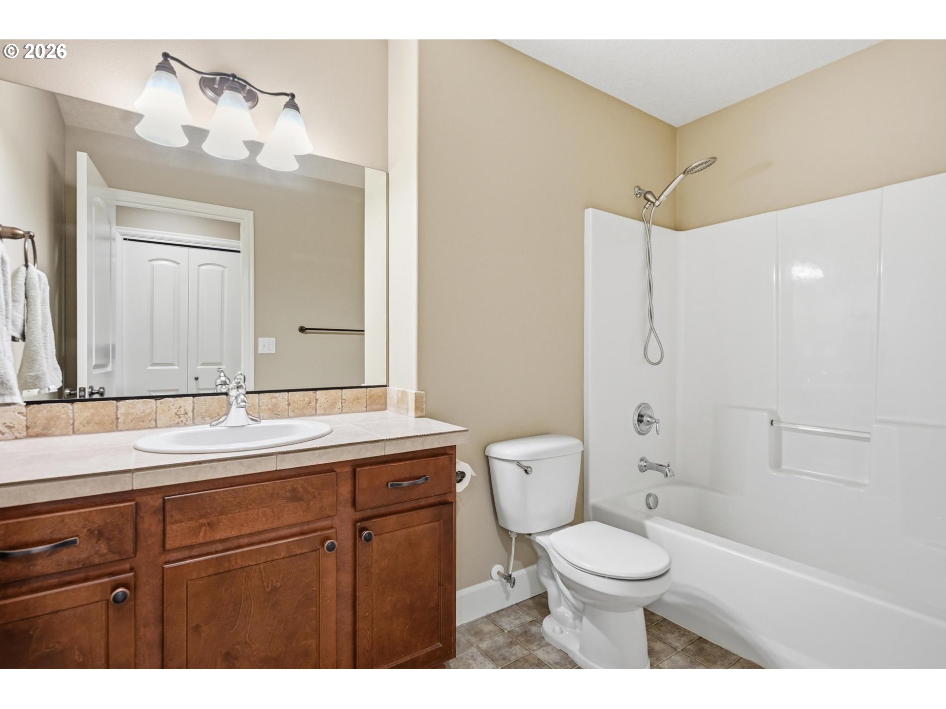 1075 Sage Street Silverton, OR 97381 - Photo 11 of 46 a bathroom with a granite countertop toilet sink and mirror