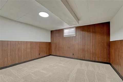 an empty room with wooden walls