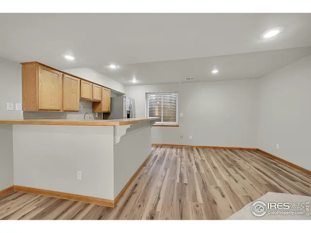 a view of a yard in front of a house with a large tree
