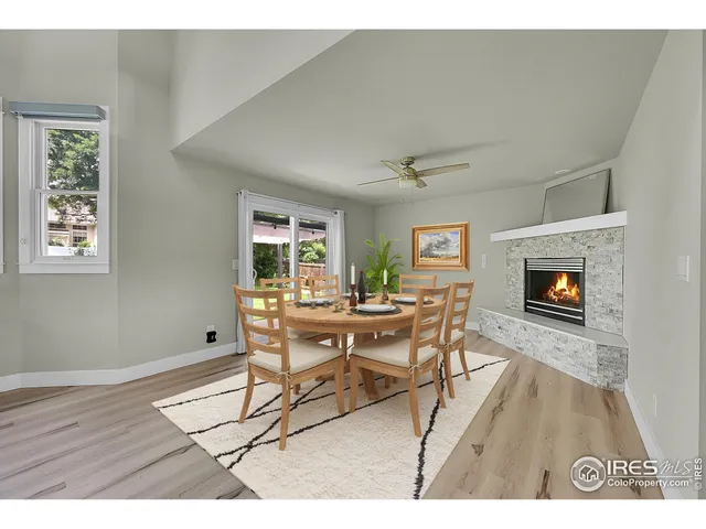 a open kitchen with stainless steel appliances granite countertop a refrigerator a sink dishwasher a stove and white countertops with wooden floor