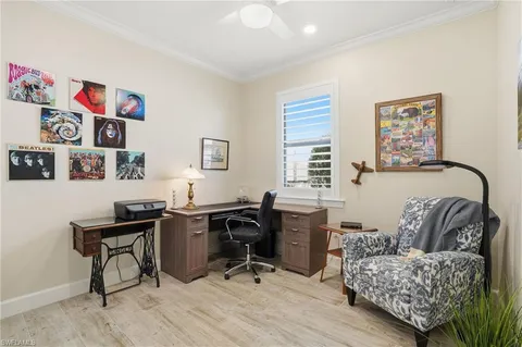 a bedroom with a bed and a flat tv screen on wall