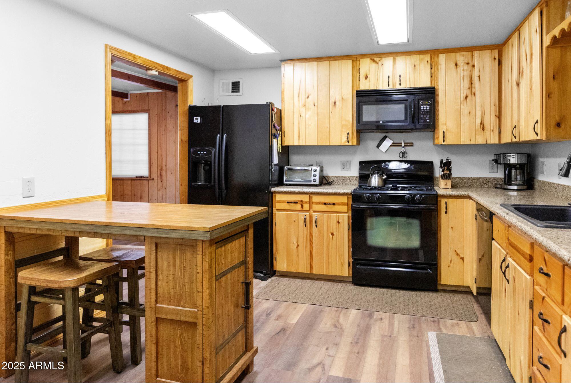 2524 Old Rim Road Forest Lakes, AZ 85931 - Photo 15 of 44 a kitchen with stainless steel appliances a stove a sink dishwasher and cabinets