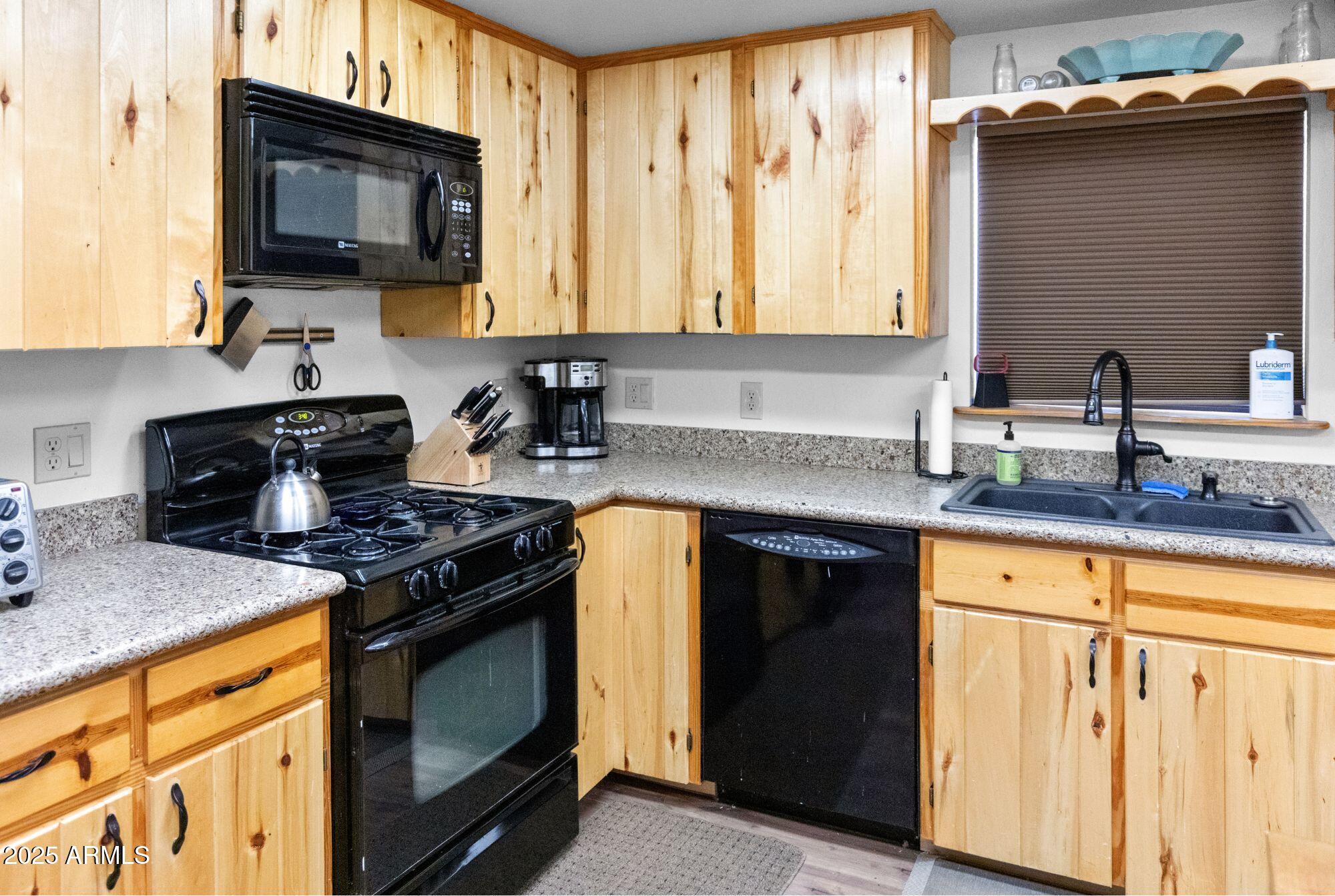 2524 Old Rim Road Forest Lakes, AZ 85931 - Photo 16 of 44 a kitchen with stainless steel appliances granite countertop a stove a sink and a microwave