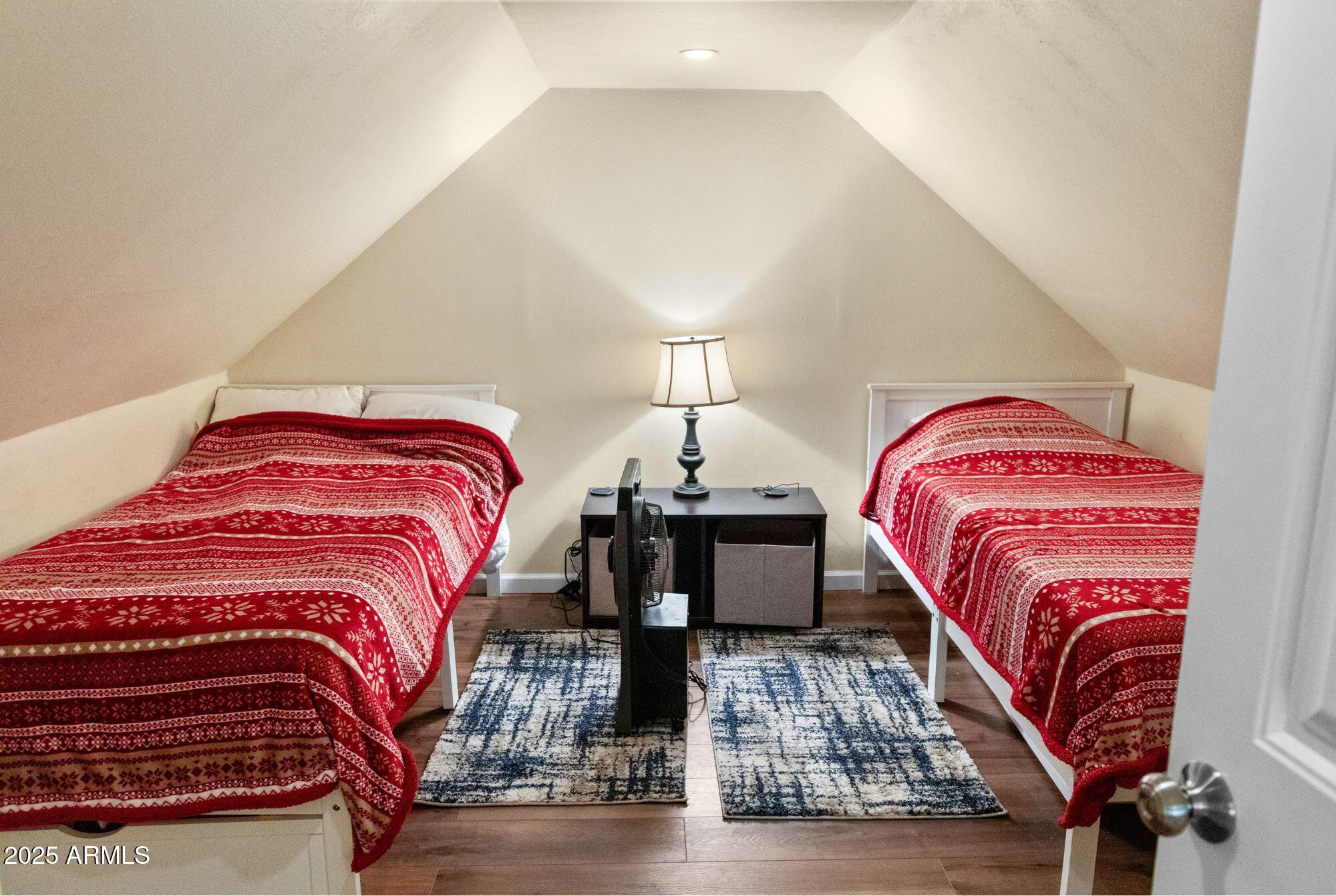 2524 Old Rim Road Forest Lakes, AZ 85931 - Photo 29 of 44 a bedroom with a bed and wooden floor