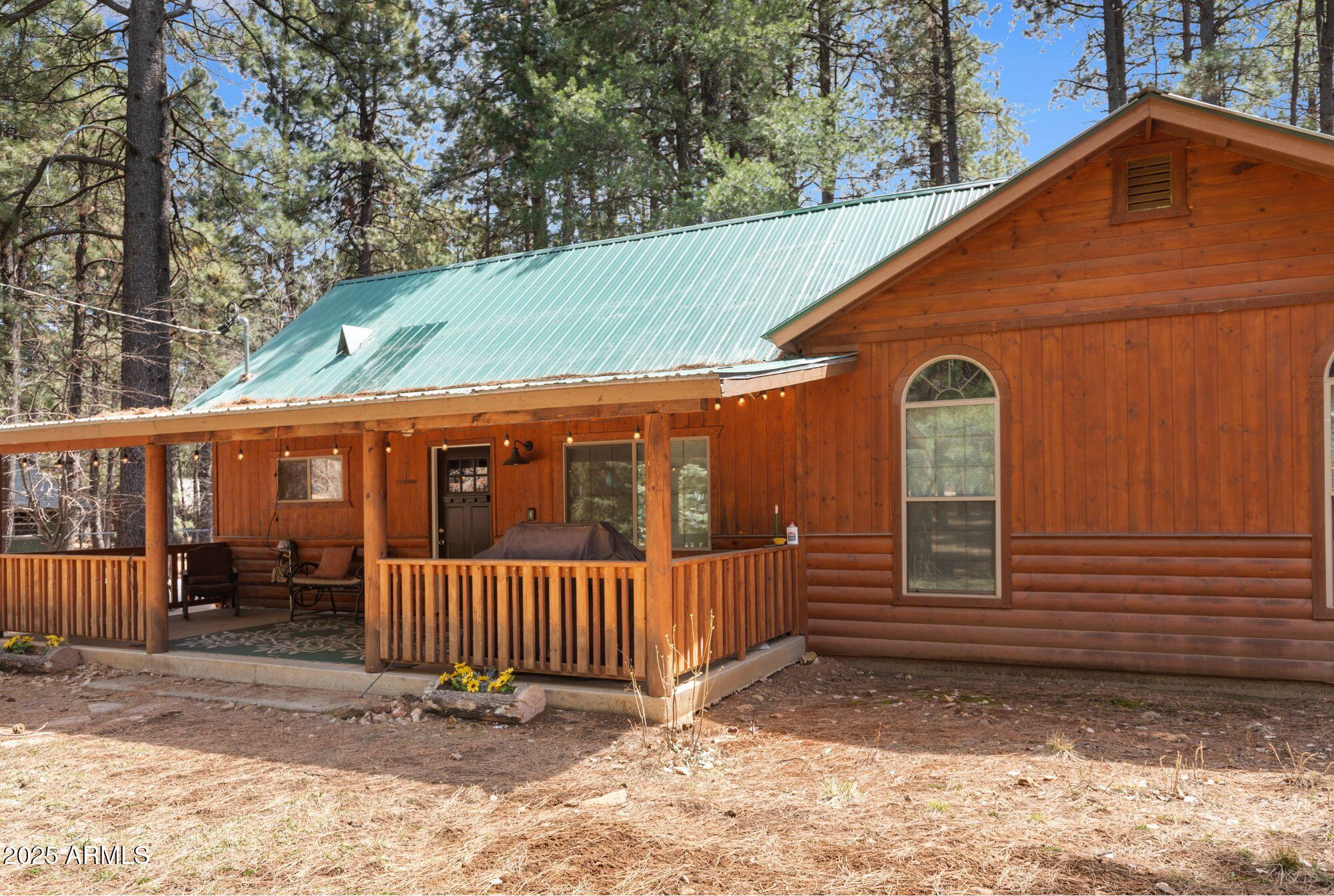 2524 Old Rim Road Forest Lakes, AZ 85931 - Photo 3 of 44 a view of a small house with wooden fence