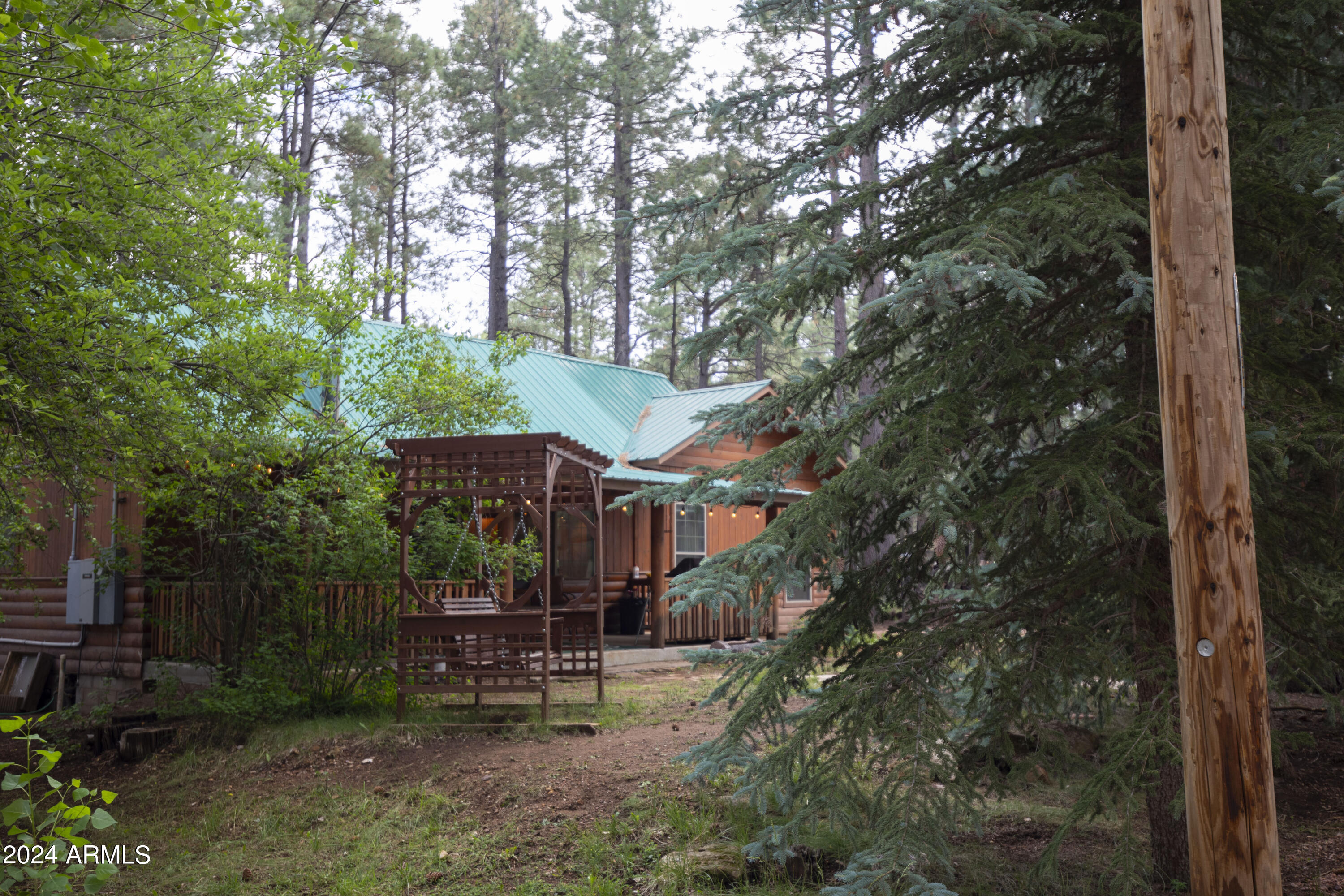 2524 Old Rim Road Forest Lakes, AZ 85931 - Photo 35 of 44 a view of a patio with table and chairs under an umbrella