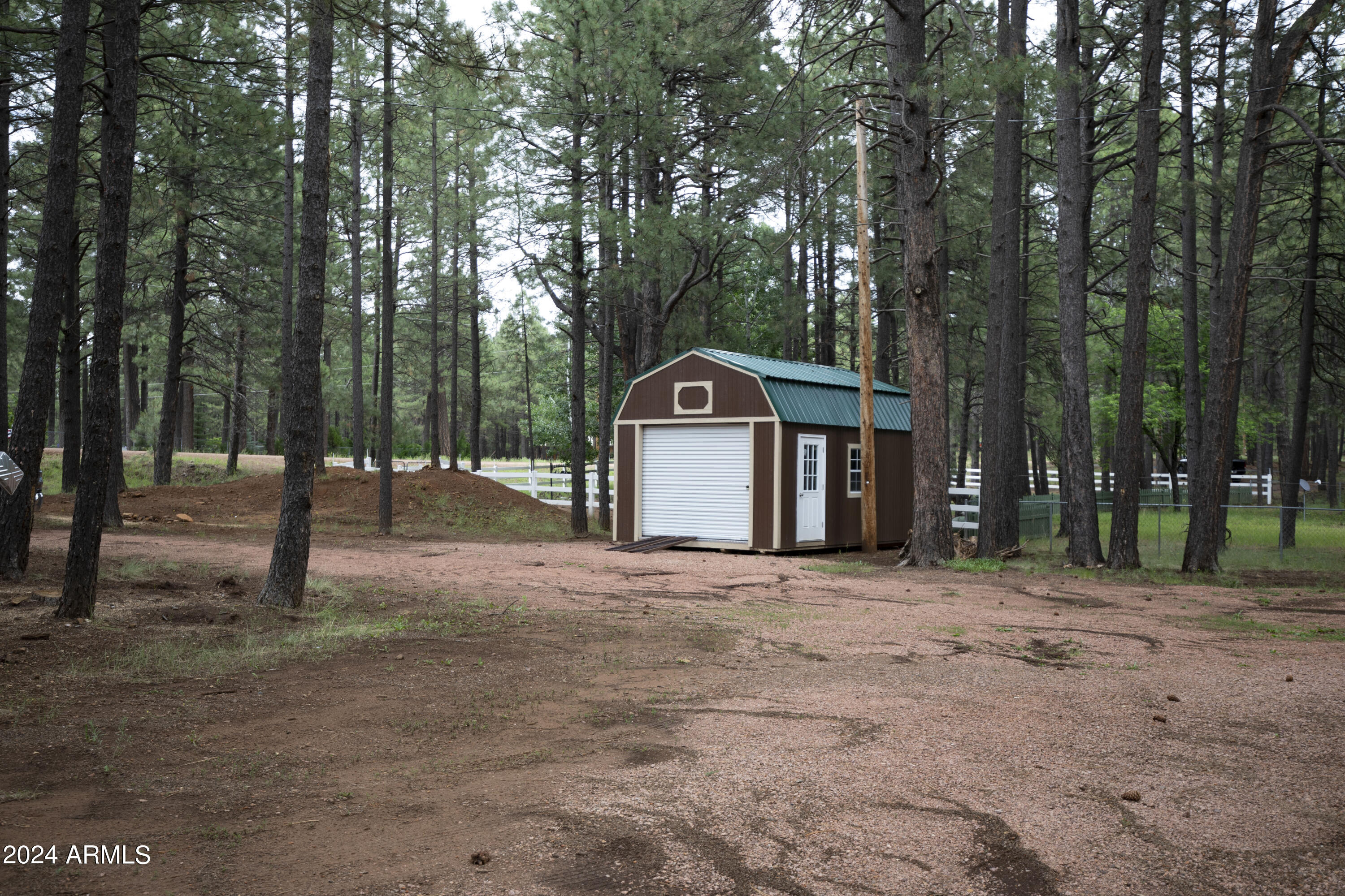 2524 Old Rim Road Forest Lakes, AZ 85931 - Photo 38 of 44 a front view of a house with a yard and garage
