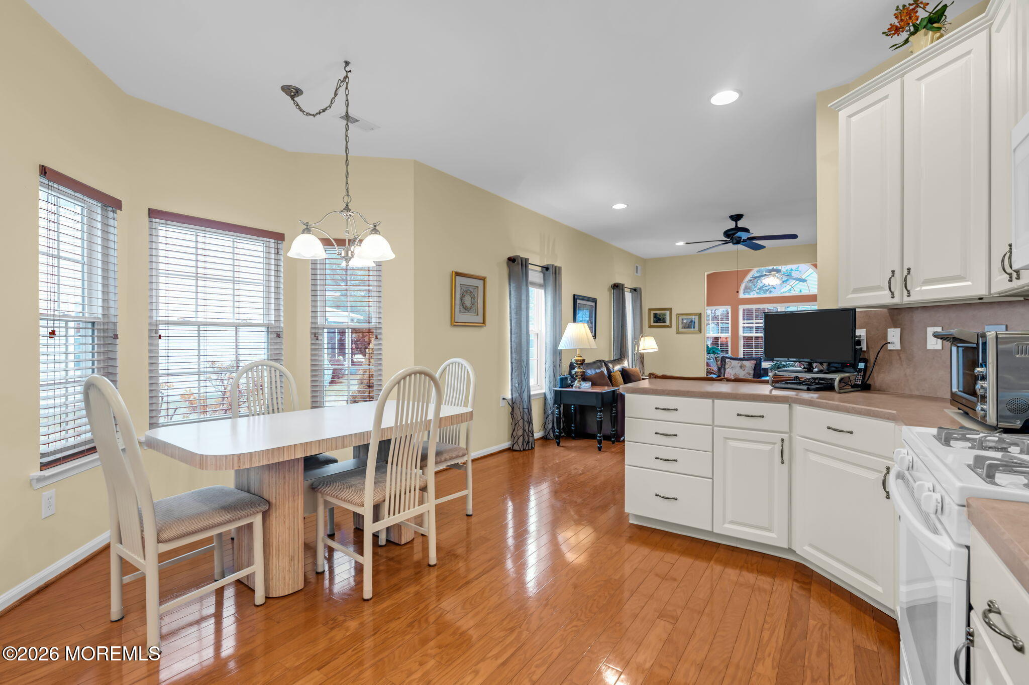 17 Rochford Drive Manchester Township, NJ 08759 - Photo 16 of 55 a kitchen with stainless steel appliances granite countertop a dining table chairs stove and white cabinets