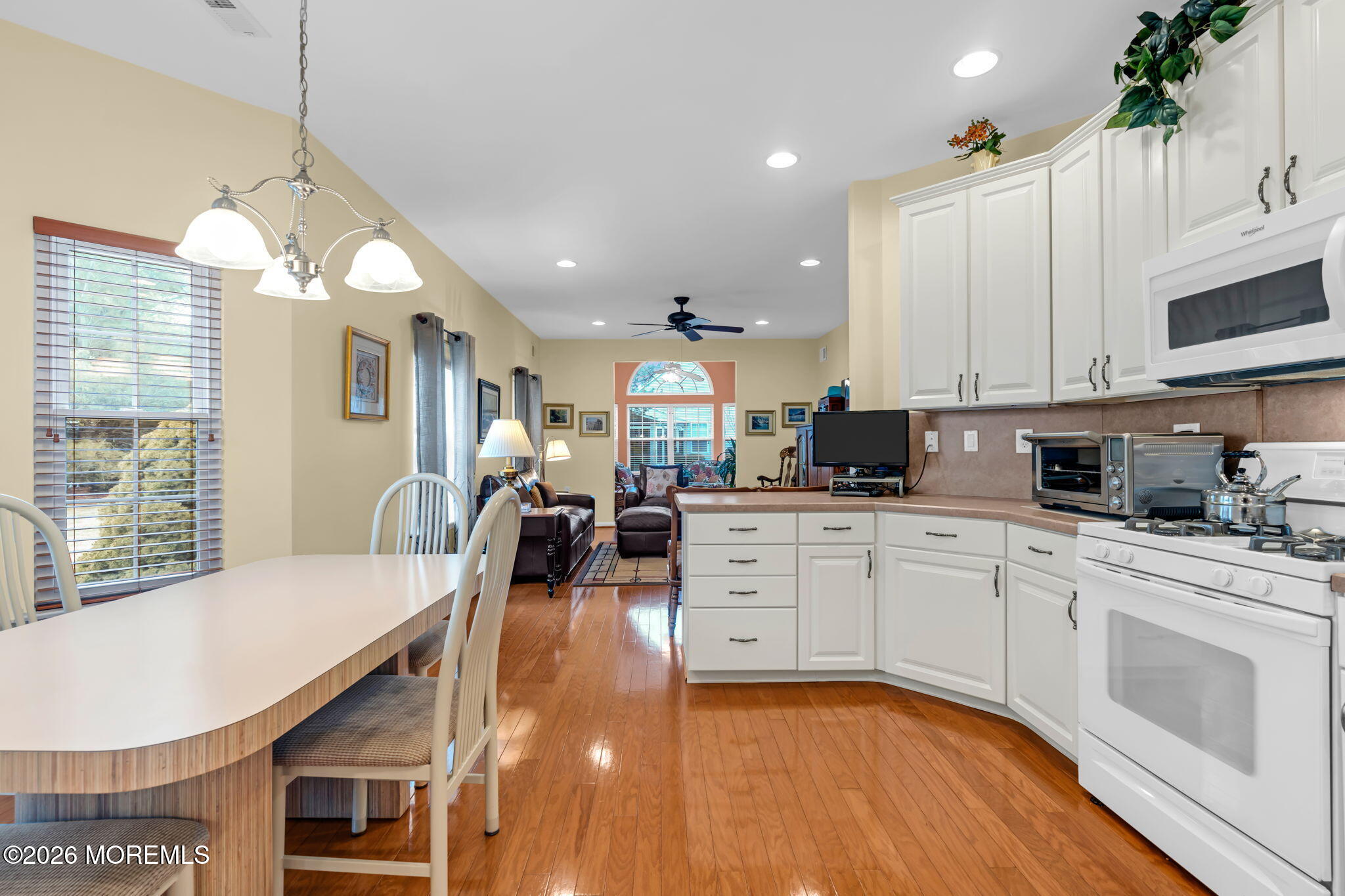 17 Rochford Drive Manchester Township, NJ 08759 - Photo 17 of 55 a kitchen with stainless steel appliances kitchen island granite countertop a stove a sink a refrigerator and white cabinets with wooden floor