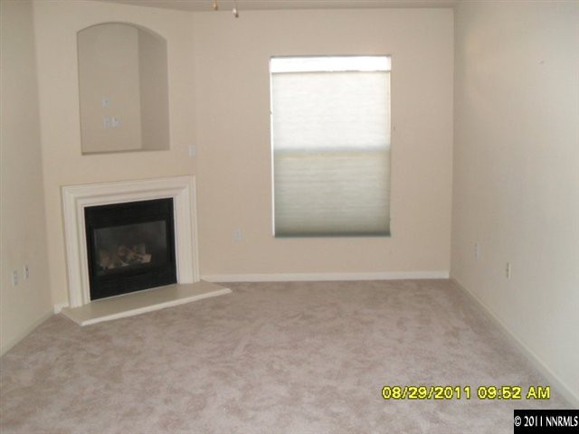 9050 Double R Boulevard, Unit 1812 Reno, NV 89521 - Photo 2 of 8 a view of an empty room with a fireplace and a window