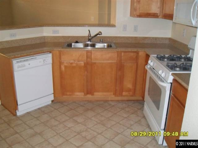 9050 Double R Boulevard, Unit 1812 Reno, NV 89521 - Photo 3 of 8 a kitchen with a sink and a stove top oven
