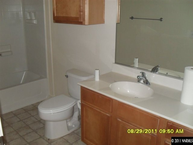 9050 Double R Boulevard, Unit 1812 Reno, NV 89521 - Photo 4 of 8 a bathroom with a sink a toilet and shower
