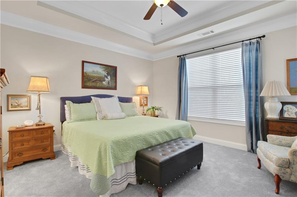 407 Windy Ridge Way Canton, GA 30114 - Photo 22 of 57 a bedroom with a bed a couch and a window