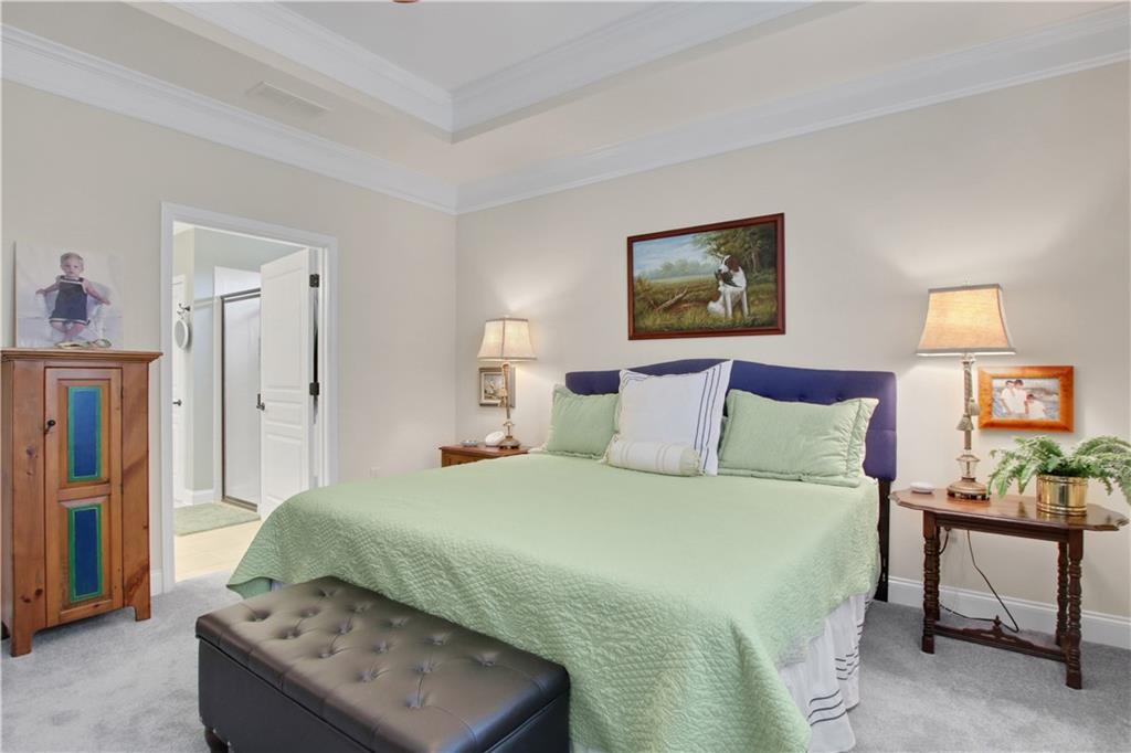 407 Windy Ridge Way Canton, GA 30114 - Photo 23 of 57 a bedroom with a bed and a table in it