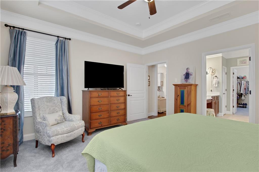 407 Windy Ridge Way Canton, GA 30114 - Photo 24 of 57 a bedroom with a bed and a flat screen tv