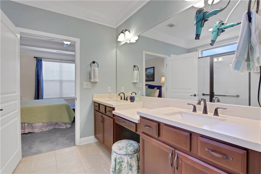 407 Windy Ridge Way Canton, GA 30114 - Photo 26 of 57 a bathroom with a sink double vanity and a mirror