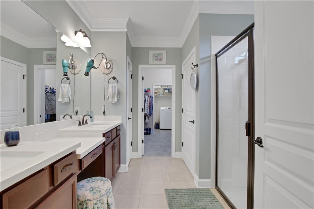 407 Windy Ridge Way Canton, GA 30114 - Photo 28 of 57 a spacious bathroom with a shower sink and a mirror