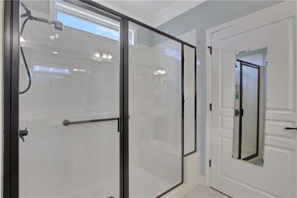 407 Windy Ridge Way Canton, GA 30114 - Photo 29 of 57 a bathroom with a glass shower door