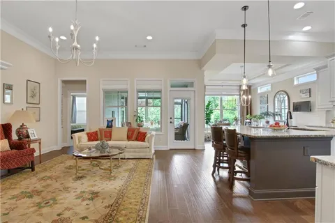 a kitchen with granite countertop a sink a stove and cabinets