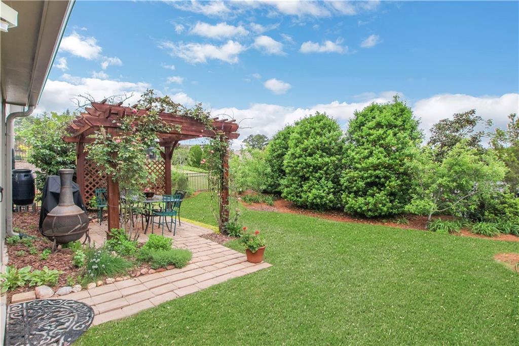 407 Windy Ridge Way Canton, GA 30114 - Photo 39 of 57 a view of a garden with a fountain