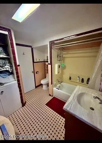 a living room with furniture a flat screen tv and a floor to ceiling window